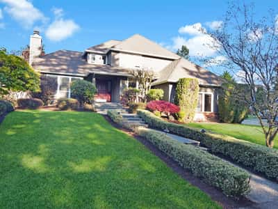 Spacious home with well-maintained landscaping, featuring a unique architectural design and ample outdoor space for entertaining.