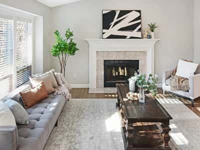 Bright living room featuring a cozy fireplace, and ample natural light throughout.