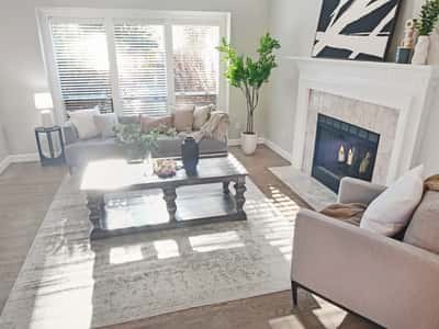 Bright and inviting living area with a cozy fireplace, and abundant natural light.