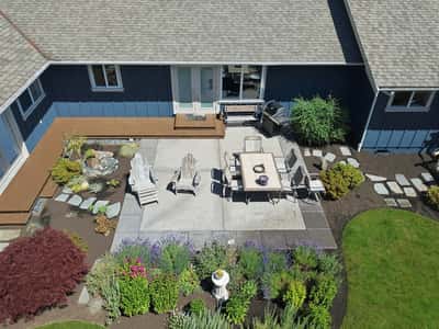 This inviting outdoor space features a spacious patio, vibrant landscaping, and a perfect area for entertaining.