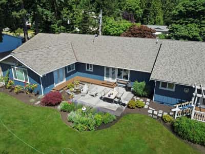 Spacious outdoor patio surrounded by vibrant landscaping offers ideal space for relaxation and gatherings.