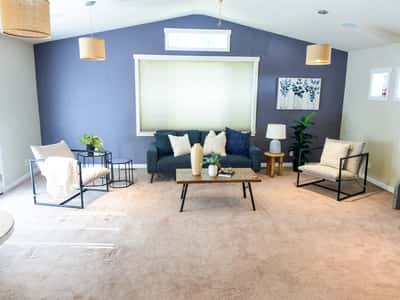 Spacious living area featuring modern furnishings, abundant natural light, and a comfortable atmosphere for relaxation.