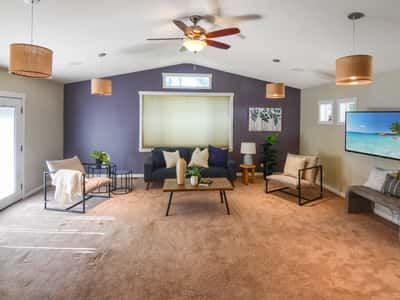 Bright and inviting living area features high ceilings, ample natural light, and modern design elements.