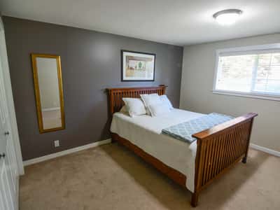 Spacious bedroom featuring natural light, ample storage, and a cozy atmosphere for peaceful relaxation.