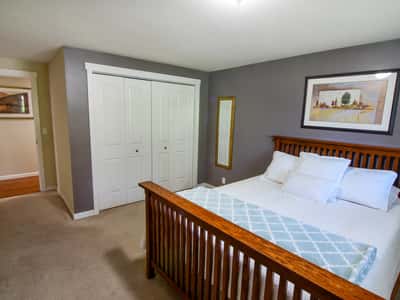 Bright and inviting bedroom featuring ample storage, modern decor, and a cozy atmosphere for relaxation.