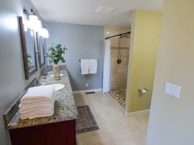 Spacious bathroom featuring a modern shower, ample countertop space, and natural light for a refreshing atmosphere.