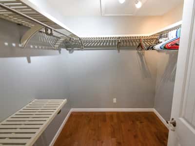 Spacious walk-in closet featuring ample shelving and hanging space, perfect for organized storage solutions.