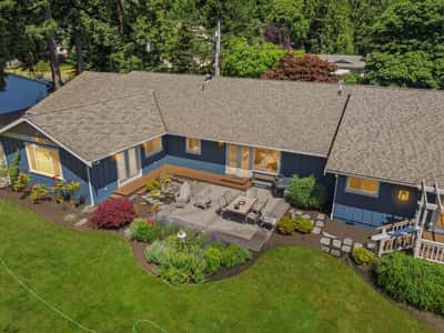 Spacious outdoor patio surrounded by vibrant landscaping, perfect for entertaining and enjoying nature’s beauty.