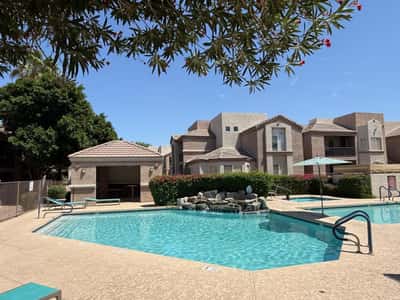 Resort-inspired pool area with ample space to relax, unwind, and enjoy Arizona sunshine. Community amenities include swimming pools, heated lap pool, spas, and gathering areas.