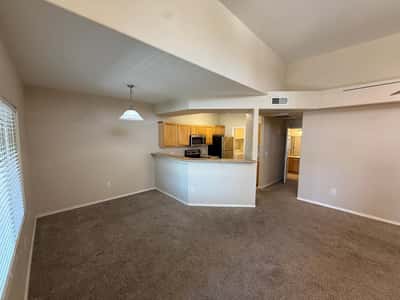 Open great room with soaring ceilings, neutral d cor, and direct connection to the kitchen. This versatile living space offers comfort, natural light, and excellent entertaining potential.