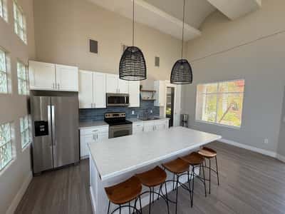 Updated community kitchen featuring a large center island, stainless steel appliances, sleek cabinetry, and designer lighting. A standout Phoenix amenity ideal for entertaining and social events.
