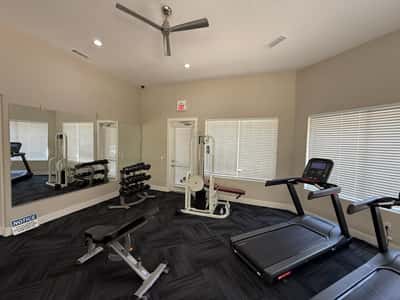 Well-maintained fitness center featuring cardio machines, weight equipment, and spacious exercise areas. Residents enjoy access to resort-style amenities within this desirable Phoenix community.