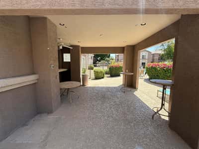 Covered outdoor gathering space near the community pool, offering comfortable seating and a shaded retreat for socializing. This desirable Phoenix community amenity enhances the overall lifestyle experience.