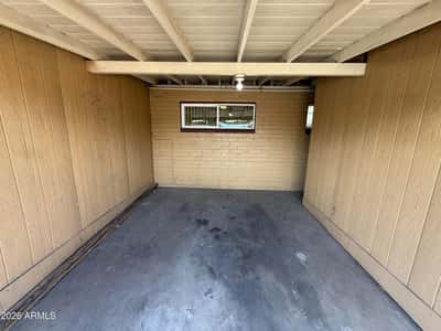 Protected carport parking space designed to provide shade and convenience year-round. This covered parking feature adds value and practicality to everyday living in Phoenix.