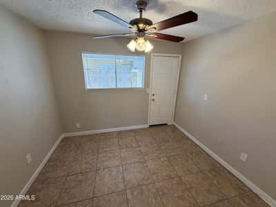 Multi-use room with tile flooring and direct access to adjoining living areas. Perfect for remote work, studying, creative projects, or additional living space tailored to your needs.