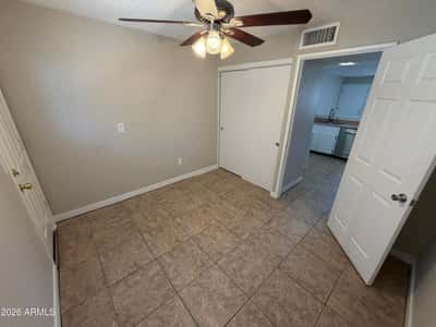 Private flex room featuring a ceiling fan, tile flooring, and natural light. A versatile area that can function as a home office, study room, workout area, or guest space.