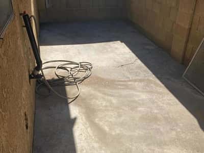 Private courtyard-style patio with block wall enclosure and durable concrete surface. This outdoor area offers opportunities for outdoor dining, entertaining, or creating a peaceful personal retreat.