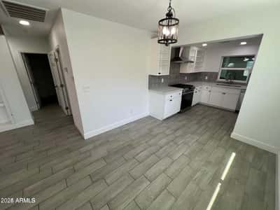 Enjoy easy entertaining with this open dining space situated next to the remodeled kitchen. Updated lighting and stylish flooring create a polished and inviting atmosphere.
