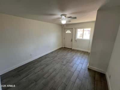 This primary bedroom offers a comfortable layout with updated finishes, ample natural light, and a ceiling fan. The room provides a relaxing private space within this beautifully remodeled home.