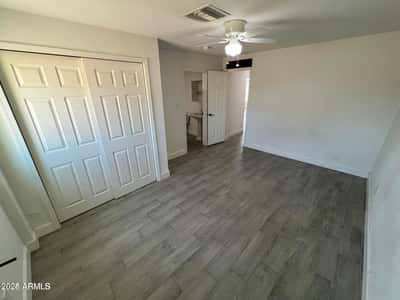Bright and inviting, this bedroom features updated flooring, neutral finishes, and flexible space for guests, family, or a home office. A comfortable addition to the home's functional layout.