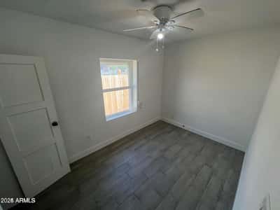 Fresh finishes, modern flooring, and natural light make this bedroom an attractive and versatile living space. Ideal for guests, family members, or creative workspace needs.