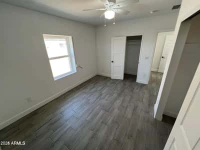 Designed for comfort and functionality, this bedroom showcases modern flooring, clean finishes, ample natural light, and convenient closet access. The flexible space easily adapts to a variety of living needs while complementing the home's updated interior.