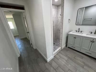 Beautiful tilework and a walk-in shower create a luxurious focal point in this remodeled bathroom. Updated cabinetry and modern finishes add both style and convenience for homeowners.