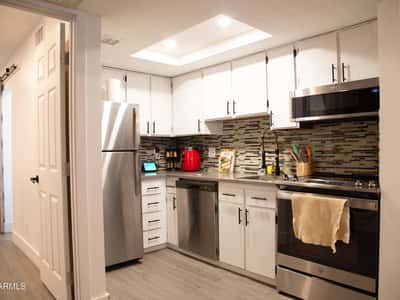 Featuring stainless steel appliances, updated cabinetry, modern fixtures, and a designer backsplash, this remodeled kitchen delivers both beauty and efficiency. Every detail has been thoughtfully updated for modern living.