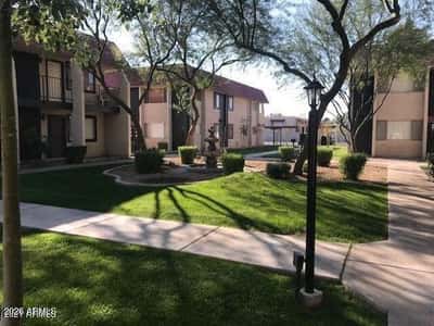 Manicured lawns, mature landscaping, and inviting gathering spaces create a welcoming community environment. Residents enjoy a blend of greenery and outdoor relaxation areas.