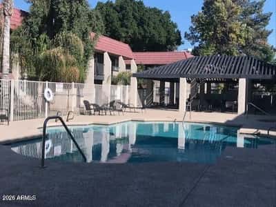 Featuring a sparkling pool, shaded seating, and attractive surroundings, this community gathering area provides an excellent place to relax and connect with neighbors.