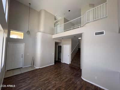 Experience a spacious interior highlighted by vaulted ceilings, architectural details, and a loft overlook. Natural light enhances the home's airy feel while providing a warm and welcoming atmosphere.