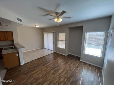 Enjoy casual dining with views of the backyard and convenient access through the sliding glass door. Large windows bring in natural light, creating a cheerful space for meals and gatherings.
