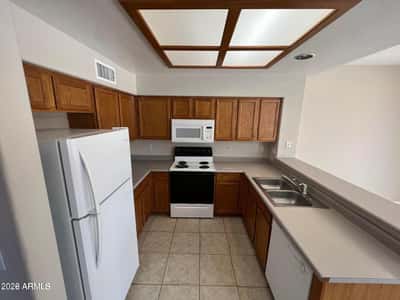 Featuring generous cabinetry, included appliances, and practical workspace, this kitchen is designed to keep everything within easy reach. Its central location makes it a natural hub for daily life and entertaining.