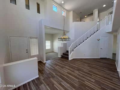 This spacious interior highlights impressive ceiling heights, contemporary finishes, and an elegant staircase. The open floor plan provides flexibility for entertaining and everyday comfort.