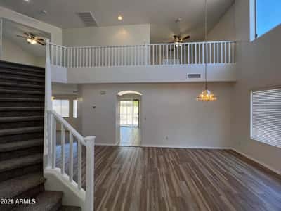 The open design features loft-style architecture, soaring ceilings, and abundant natural light. This impressive gathering space creates a sense of openness throughout the home.