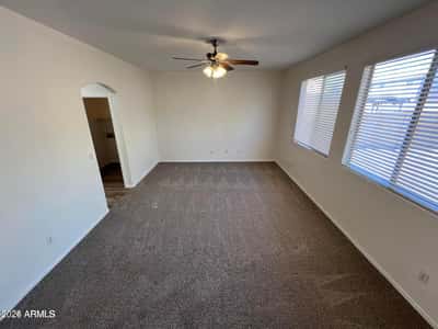 Multiple windows and generous dimensions make this primary suite feel bright and inviting. The large floor plan offers flexibility for a sitting area, workspace, or reading nook.