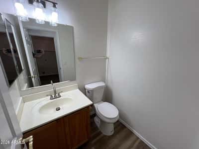 Well-appointed powder room featuring updated fixtures, modern vanity lighting, and durable flooring. A practical and attractive space for guests and daily use.