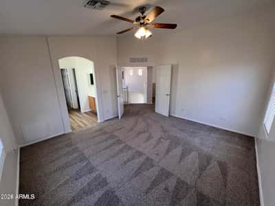 Spacious bedroom featuring neutral finishes, soft carpeting, and a versatile layout. Easily adaptable as a guest room, hobby room, home office, or personal retreat.