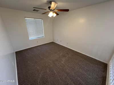 Comfortable upstairs bedroom with fresh carpeting, ceiling fan, neutral d cor, and abundant natural light. A flexible space suited for a variety of living needs.