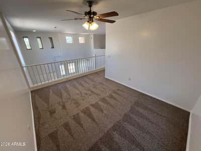Open loft overlooking the foyer and living spaces below, providing room for a home office, playroom, media center, or additional lounge area.
