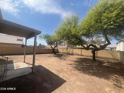 Enjoy a spacious backyard highlighted by mature trees, a covered patio, and plenty of room to create your ideal outdoor oasis. This private outdoor space offers endless possibilities for relaxation, entertaining, and future enhancements in Goodyear.