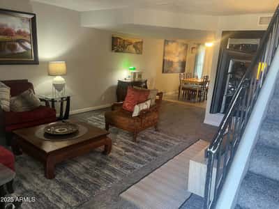 Spacious living area features a functional floor plan with comfortable gathering space that flows naturally into the dining room and kitchen.