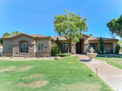 The attractive front elevation features stone architectural details, lush landscaping, a paver walkway, and an inviting covered entry. Exceptional curb appeal welcomes you to this beautiful home in Glendale.