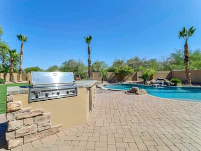 Relax beside the sparkling pool while enjoying the built-in barbecue, waterfall feature, paver patio, and beautifully landscaped backyard. This Glendale home offers resort-style outdoor living at its finest.