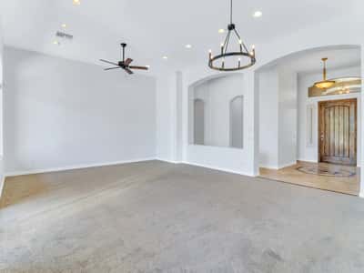 Soaring ceilings, elegant lighting, recessed lights, plush carpeting, and decorative archways create a bright and inviting formal living space. This Glendale home offers an open design perfect for entertaining.