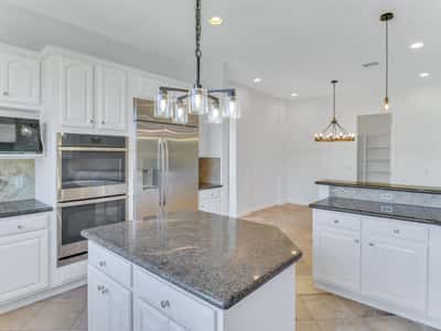 Enjoy preparing meals in a spacious kitchen complete with granite countertops, stainless steel appliances, extensive cabinetry, pendant lighting, and an oversized island. This Glendale home is designed for entertaining.