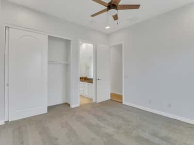 Comfortable bedroom featuring neutral finishes, plush carpet, ceiling fan, spacious closet, and convenient bathroom access. A versatile room ideal for guests, family, or a private office in Glendale.
