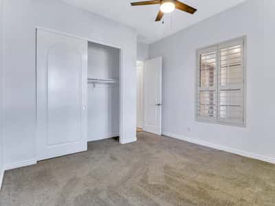 Well-appointed bedroom with generous closet space, plantation shutters, soft carpeting, and neutral d cor. This Glendale property provides comfortable space for guests, family, or a home office.
