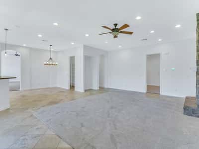 Open-concept living area with soaring ceilings, recessed lighting, plush carpeting, and seamless access to the dining and kitchen spaces. This Glendale home is ideal for entertaining and everyday comfort.