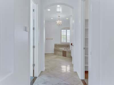 The inviting entrance leads into a luxurious primary bathroom with elegant tile flooring, plantation shutters, an oversized soaking tub, and spacious design. A refined feature of this beautifully maintained Glendale home.